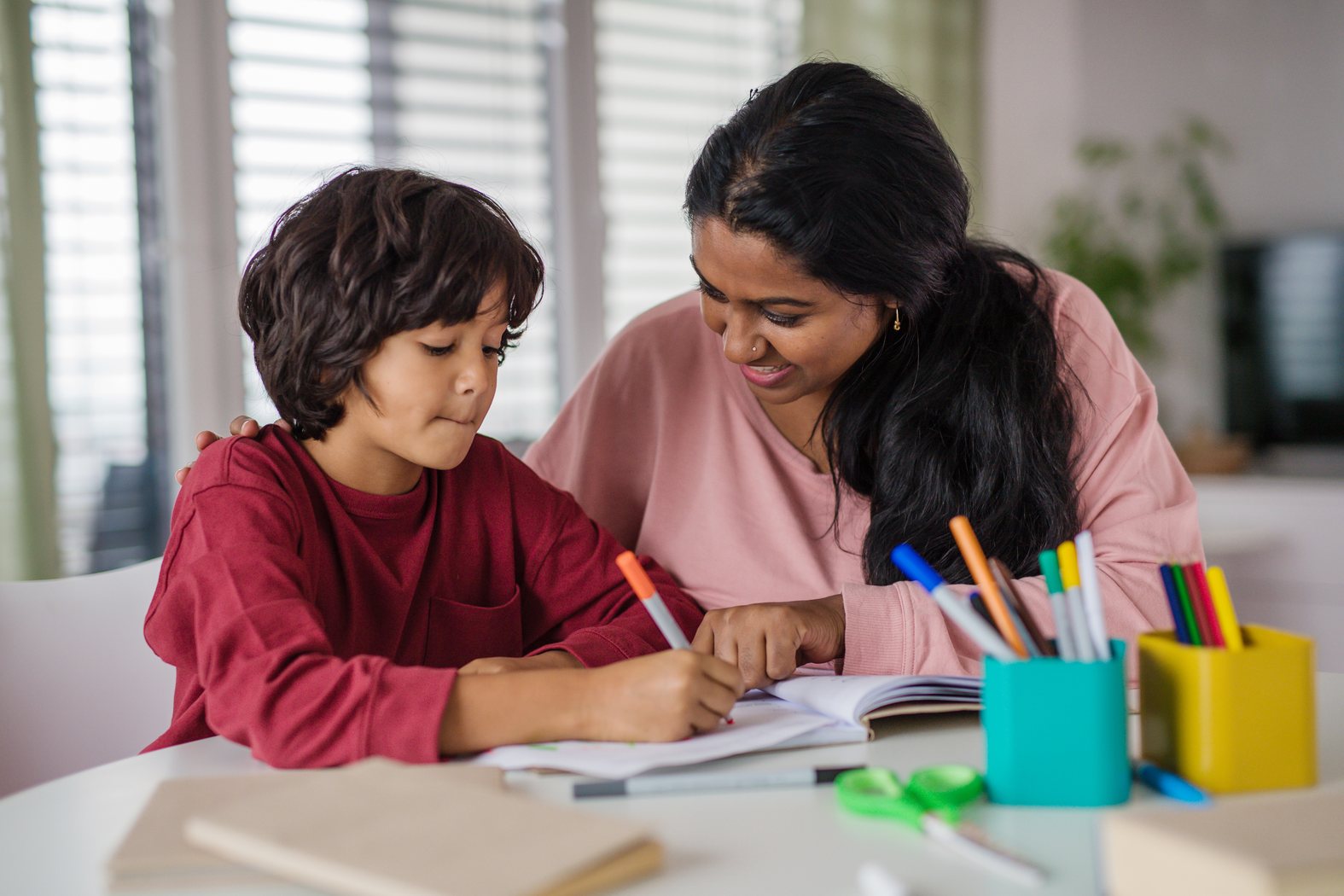 Adult supporting a child during focused learning